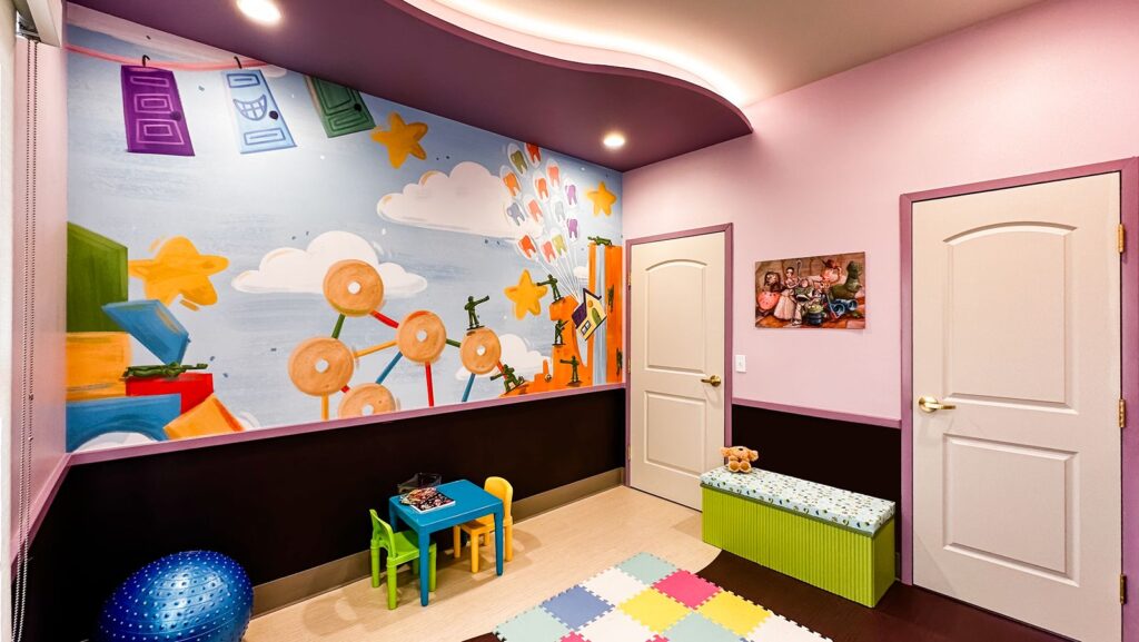 Kids’ playroom featuring colorful walls, soft flooring, and modern pediatric dental interior design.