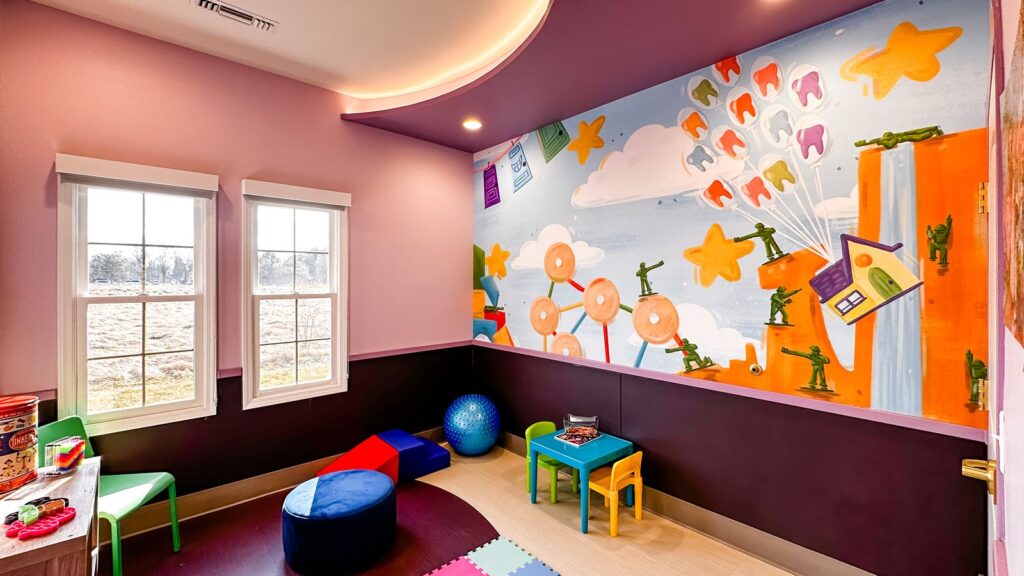 Kids’ playroom featuring colorful walls, soft flooring, and modern pediatric dental interior design.