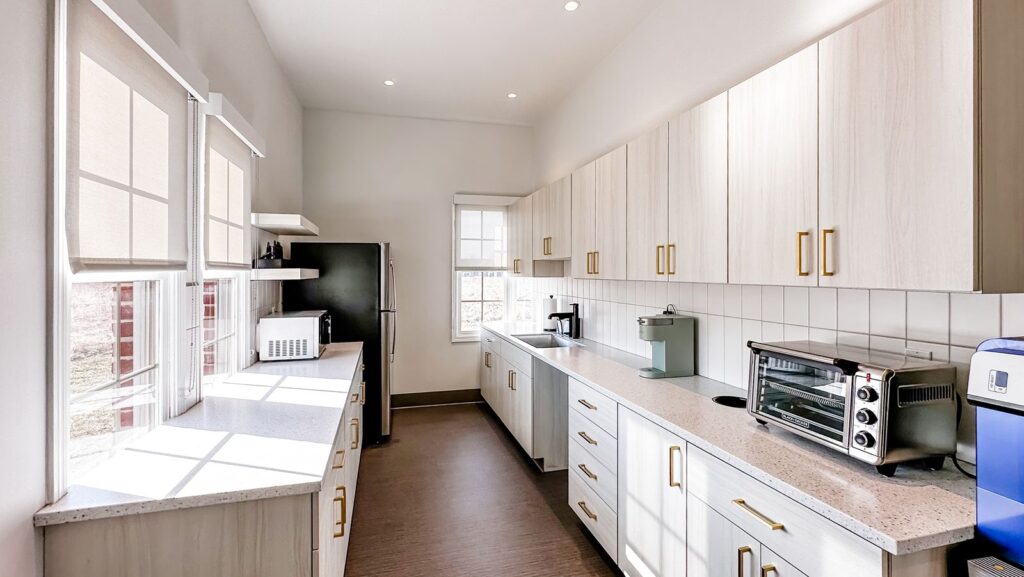 Breakroom and kitchenette featuring custom cabinetry and modern finishes by commercial interior design firms near Indianapolis.