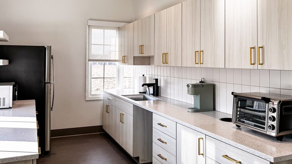 Light-filled staff kitchen showcasing natural wood tones and interior design Indiana craftsmanship.
