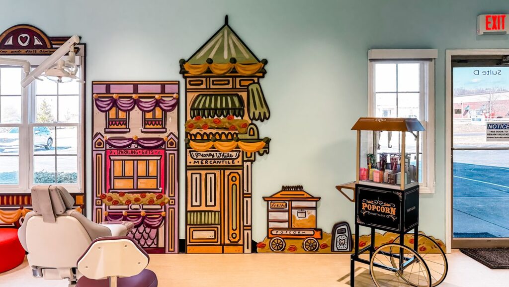 Colorful wall art and interactive play-themed design illustrating imaginative pediatric dental interior design ideas.