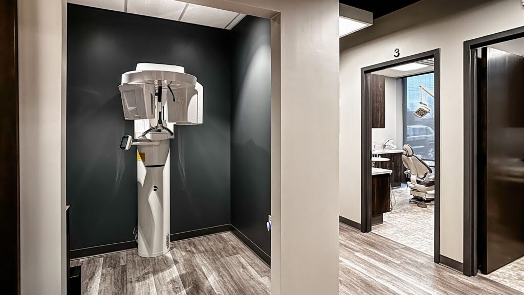 Hallway view with warm lighting and contemporary dental office design.