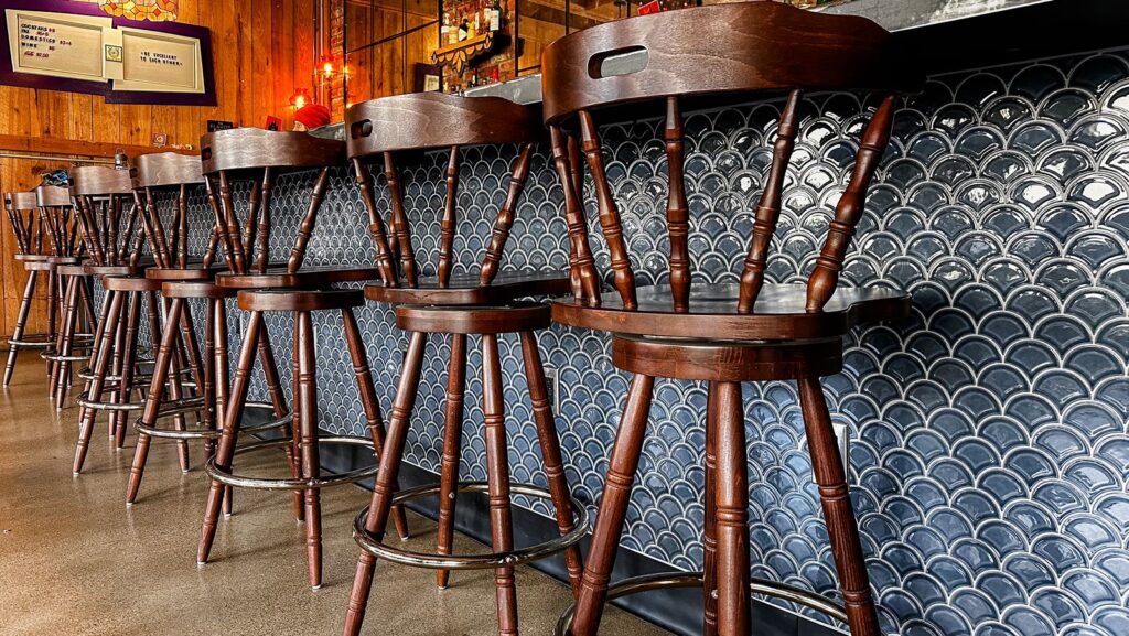 Hospitality interior design featuring warm lighting and wood seating in modern restaurant setting.