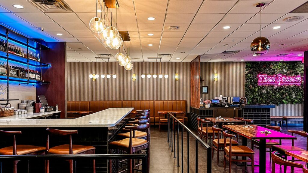 Bar and dining area with ambient lighting and polished dark flooring.