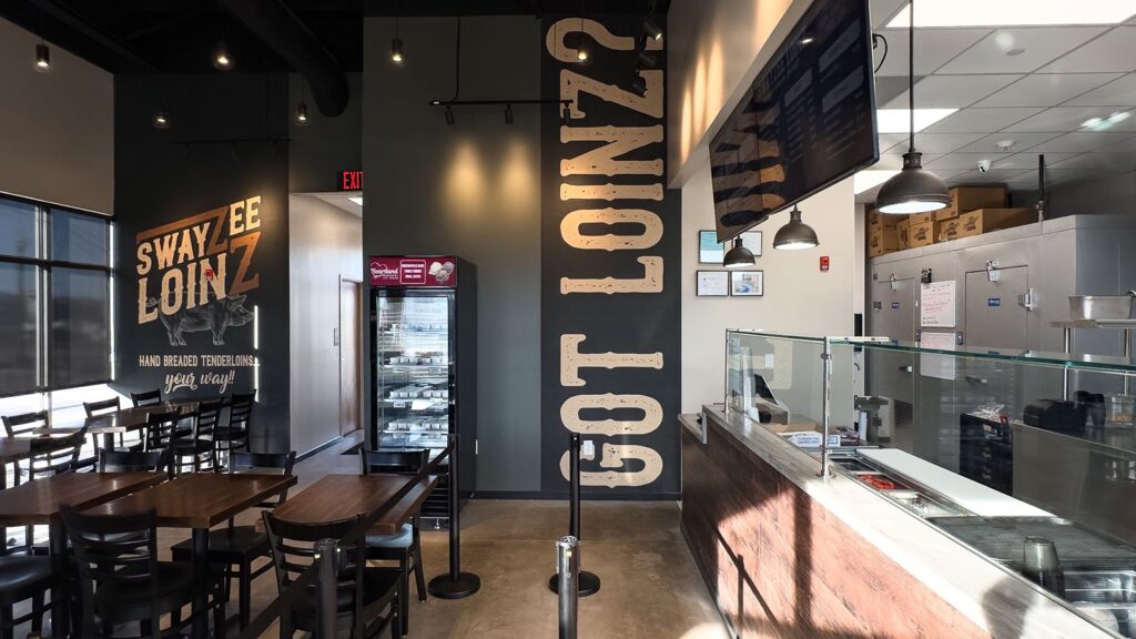 Feature wall with “Got Loinz?” typography and industrial lighting.