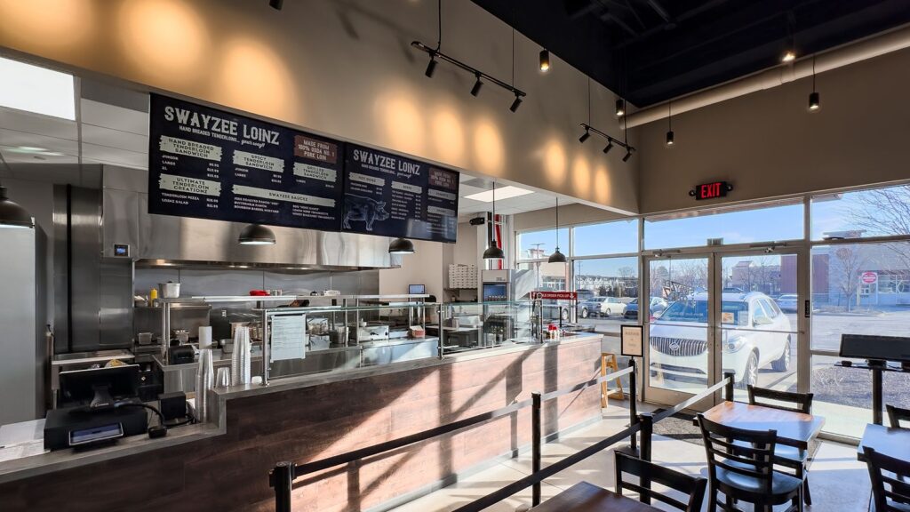 Front counter view showcasing food preparation area and hanging lights.
