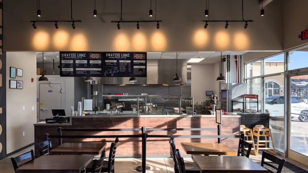 Restaurant interior featuring order counter and open kitchen layout.