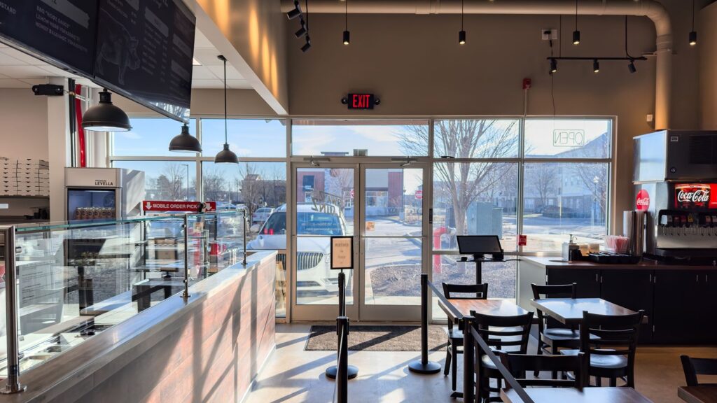 Entryway with glass doors allowing natural light into dining area.