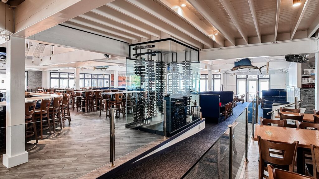 Glass wine cellar centerpiece in the restaurant dining area.