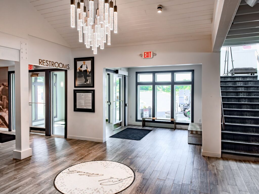 Modern entry with statement chandelier and front doors.