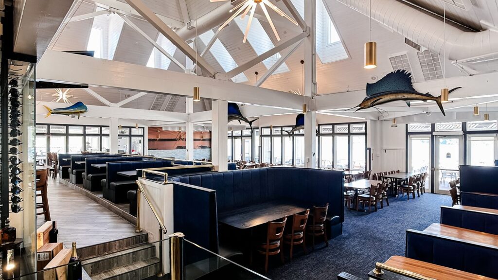 Open dining room with skylights and nautical-inspired decor.