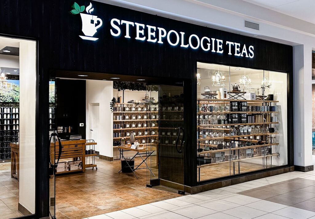 Retail entrance featuring tea canisters and display shelves.