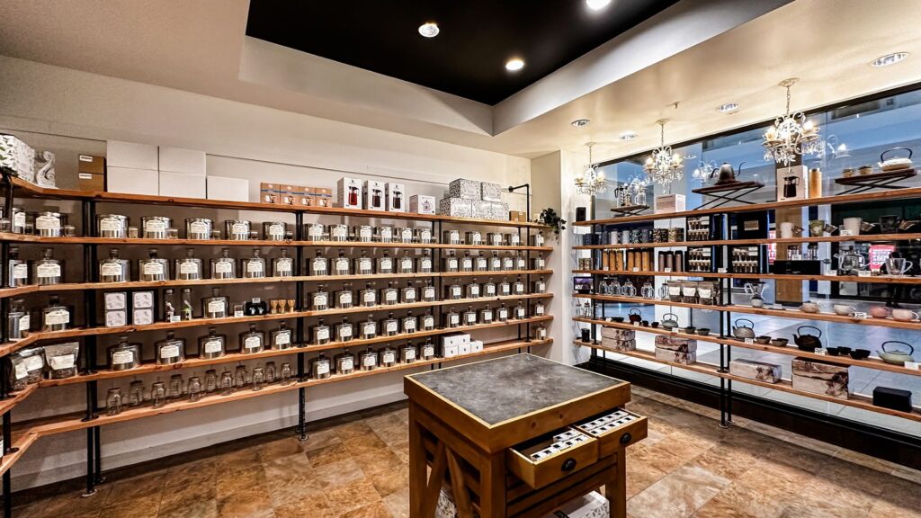 Central wooden counter surrounded by retail displays.