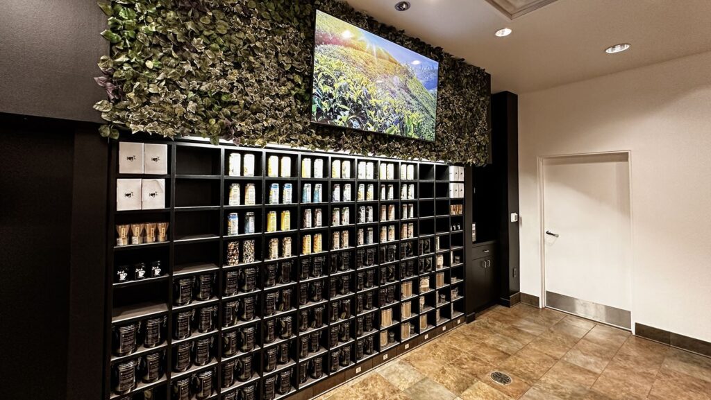 Retail shelves filled with tea canisters and glass jars.