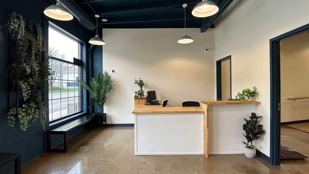 Hallway with polished concrete floors and clean modern animal hospital layout.