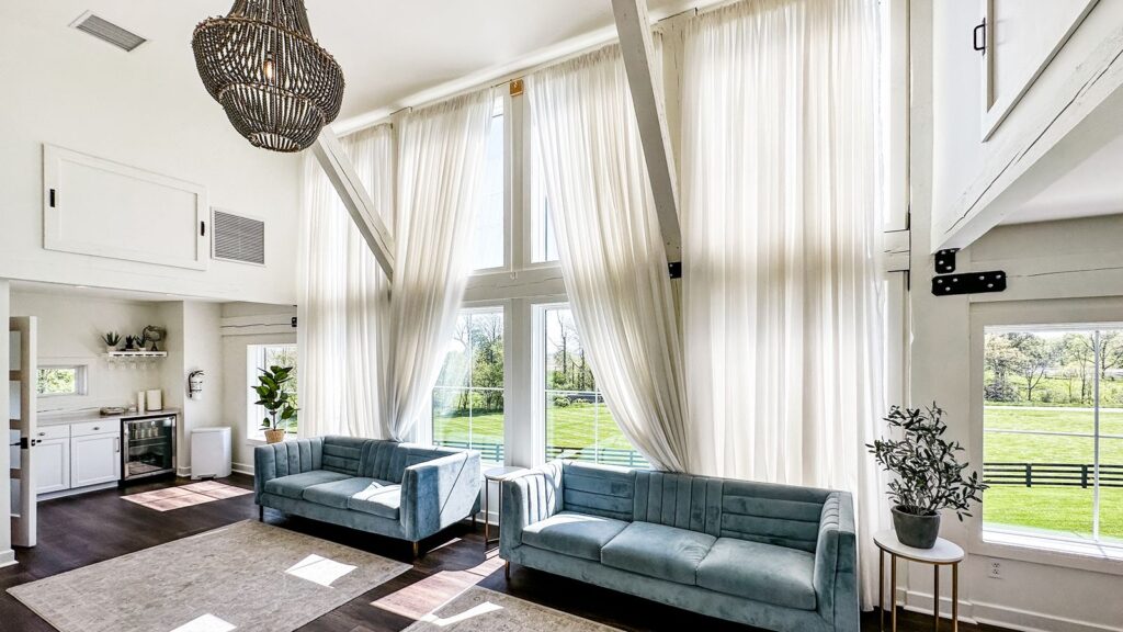 Private bridal dressing room featuring soft blue seating and white drapery.