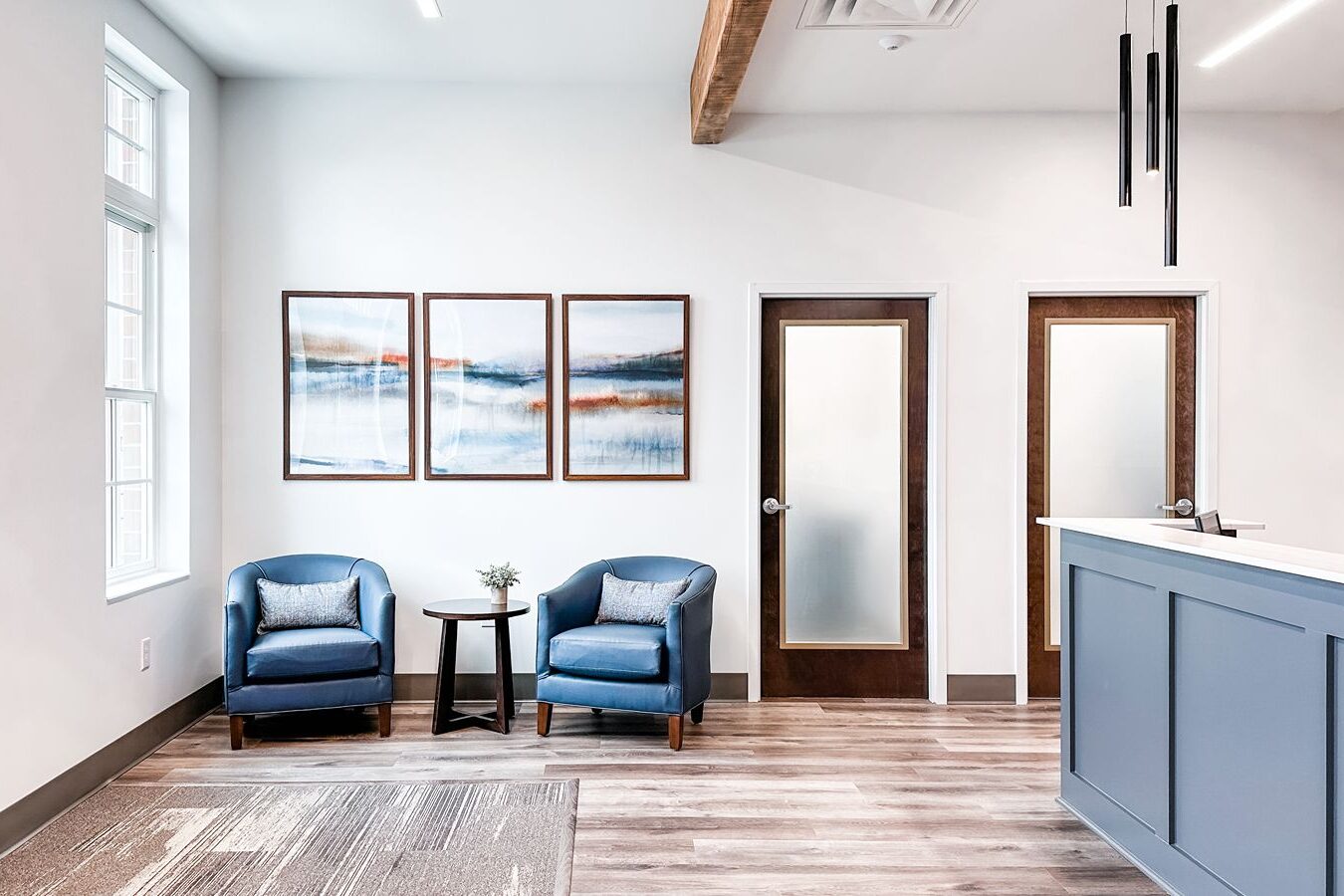 Bright, modern office reception with seating and artwork, reflecting thoughtful design when choosing the right commercial interior designer in Atlanta